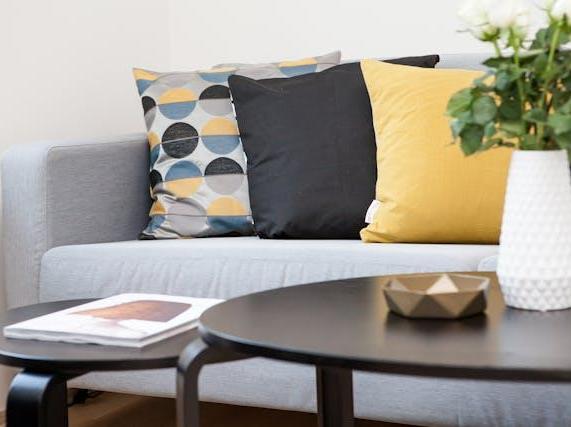Coffee Table Beside Sofa With Three Pillows